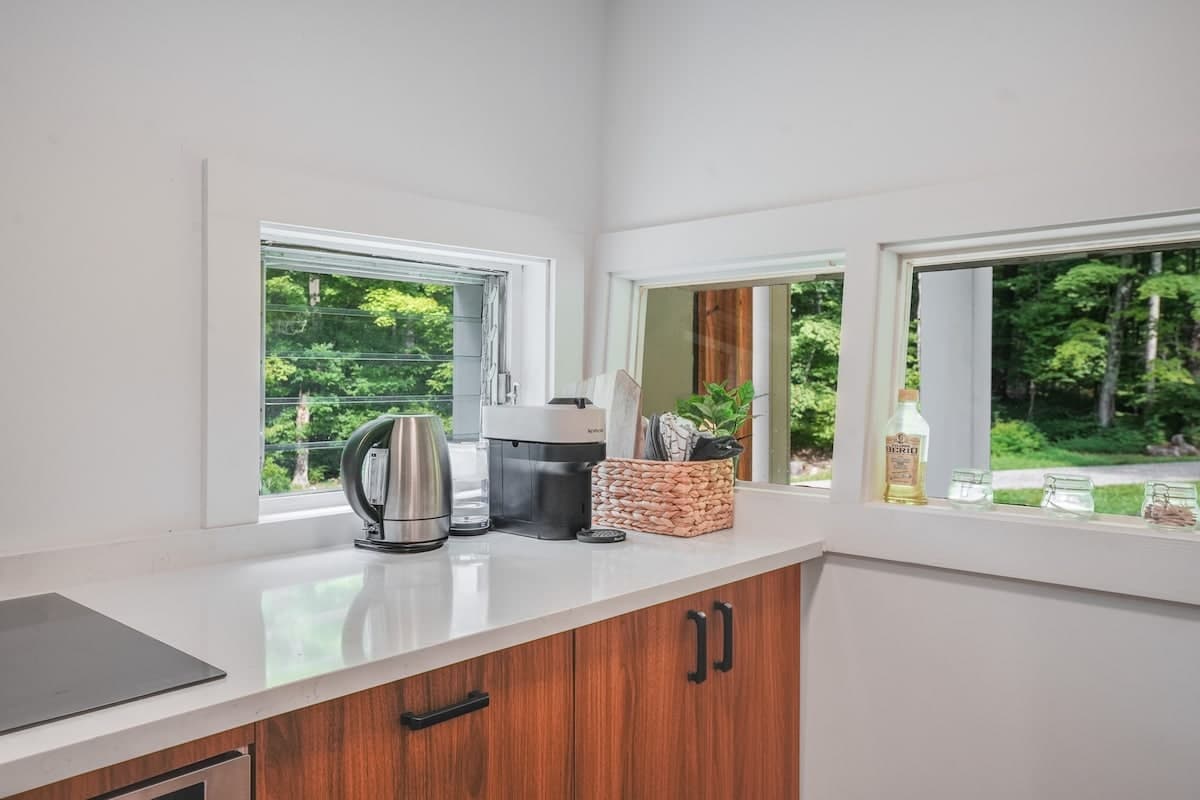 The coffee corner by the corner windows: a kettle and a Nespresso machine on the counter